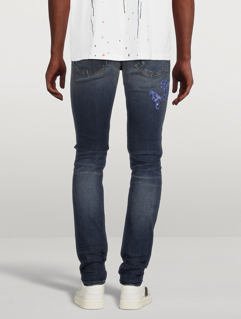 AMIRI Old English Logo Skinny Jeans | Holt Renfrew