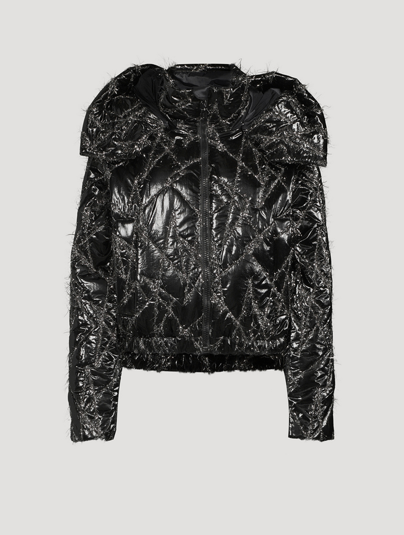 English) A black lace body with leather leggings and sequin jacket