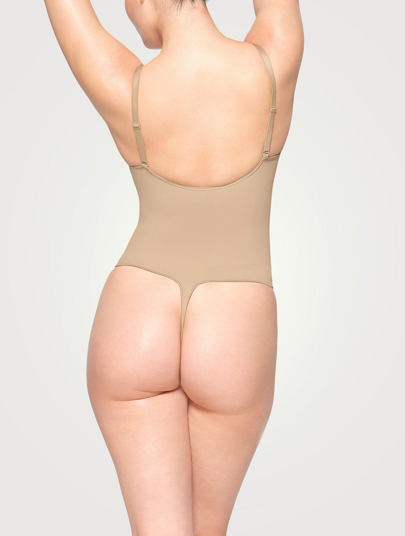 Skims Seamless Sculpt Low Back Thong Bodysuit In Sand