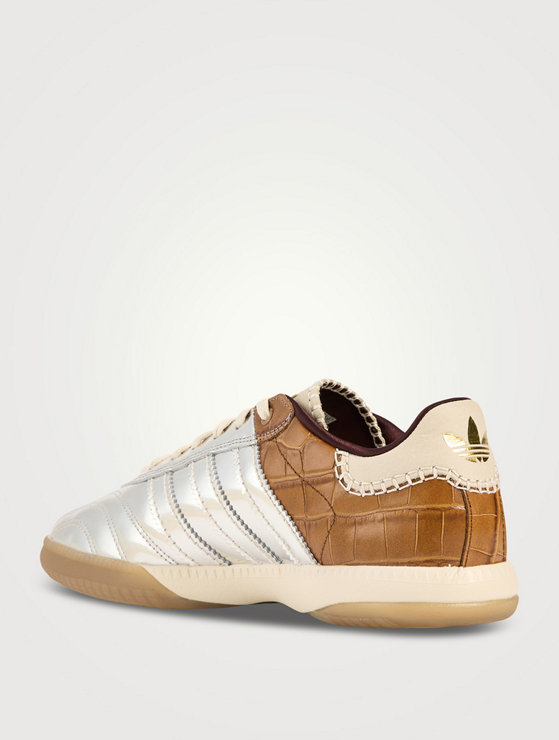 Gold designer trainers store