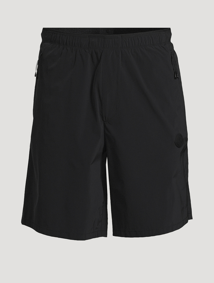 Short biextensible avec écusson à logo