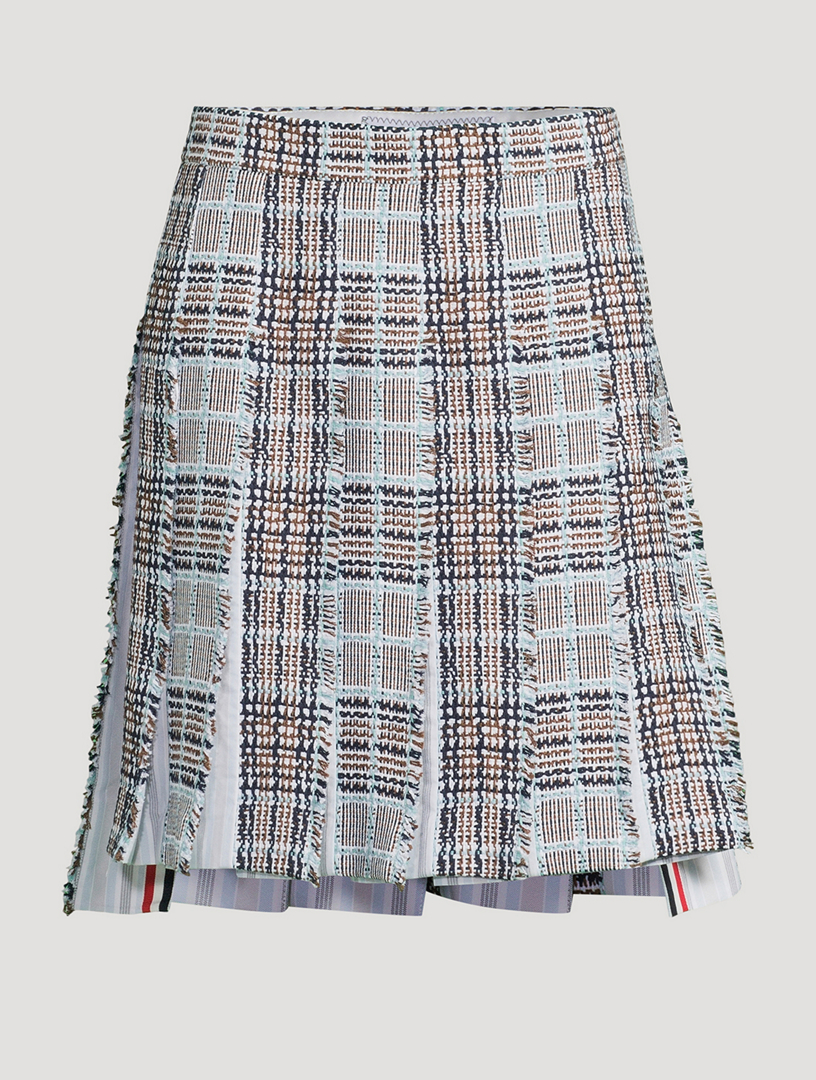 Jupe plissée en tweed à motif écossais avec bords effilochés