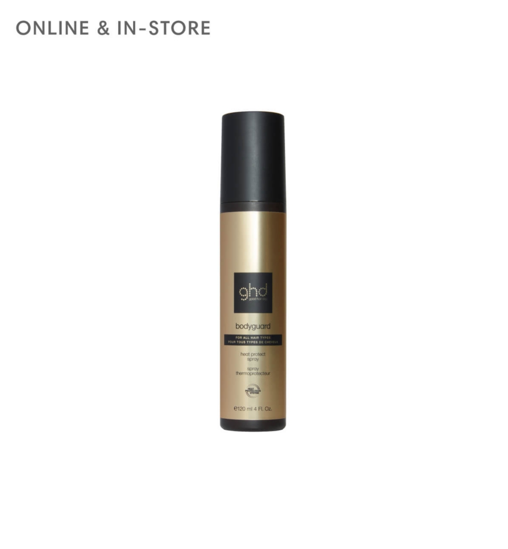 Tall gold and black hair spray bottle