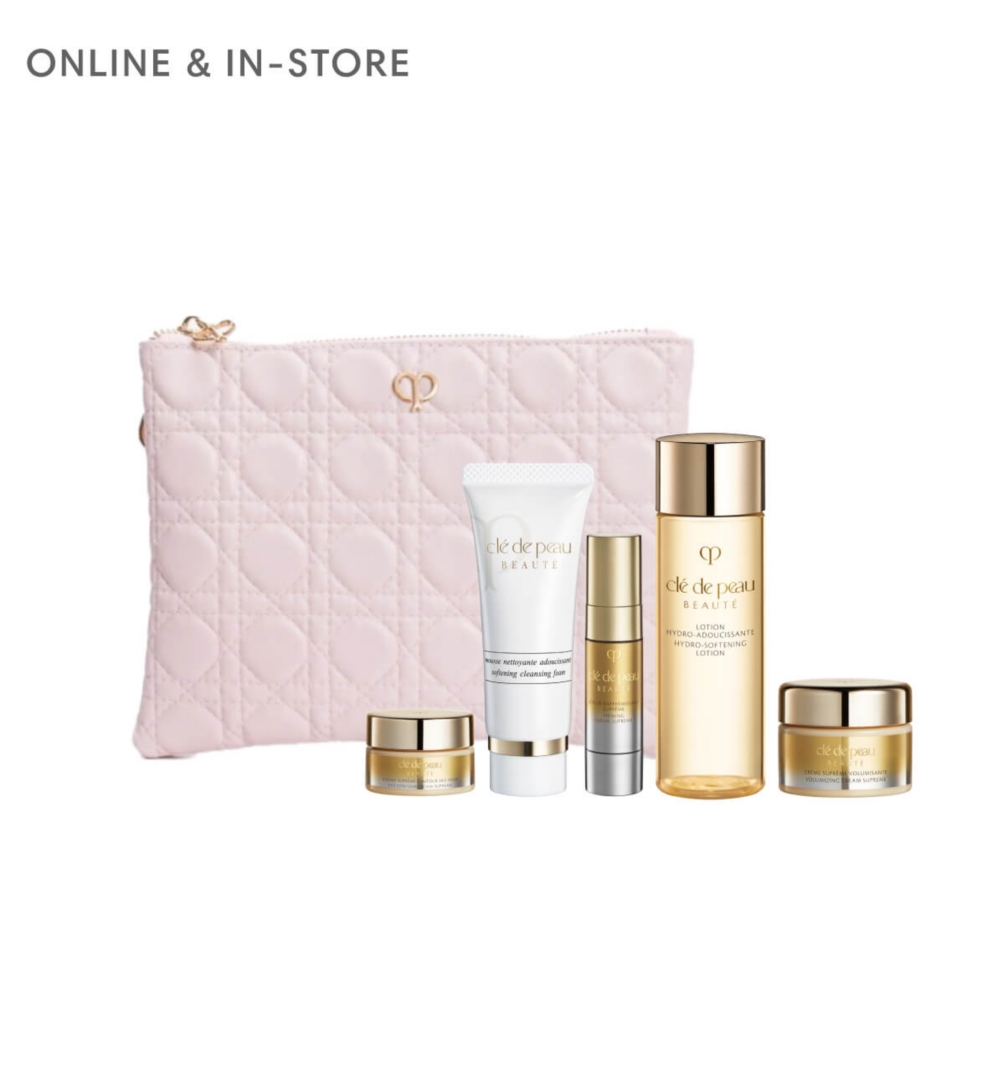A light pink pouch surrounded by Cle de Peau beauty products