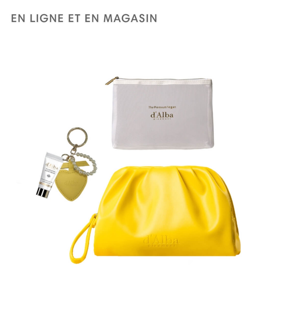 Une pochette jaune entourée de produits de beauté de d'Alba
