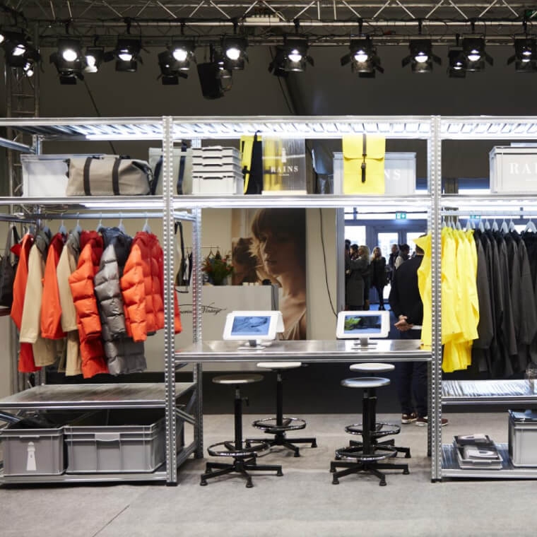 Two models posing outside in the winter tundra with a husky.