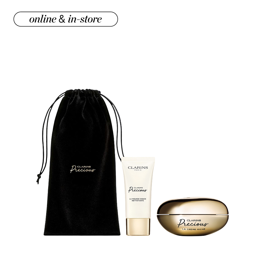 A light pink pouch surrounded by Cle de Peau beauty products