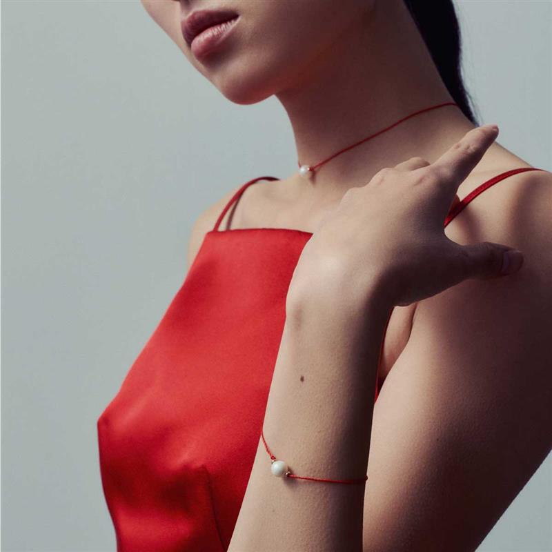 A model in a red dress shows off red threaded accessories